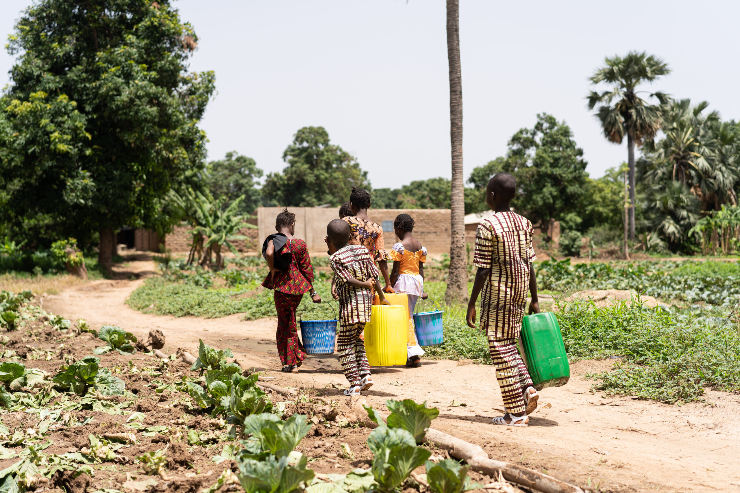 
Group of black African children walking home with empty water containers after helping their father irrigate the family field
By Riccardo Niels Mayer from Adobe Stock