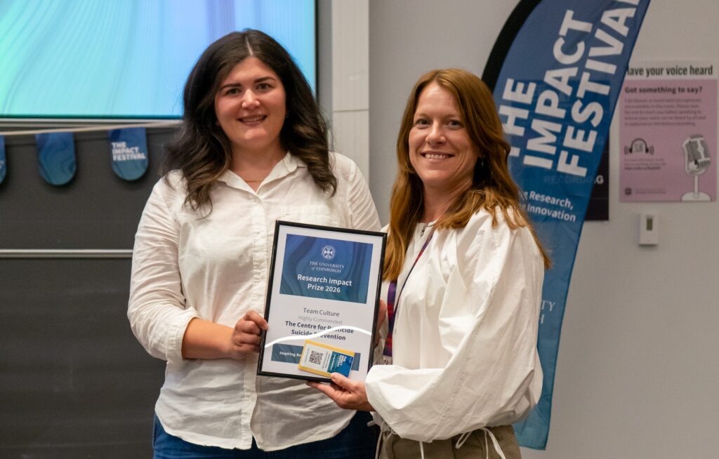 Two woman holding a certificate, which says "Research Impact Prize 2026"